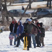 Cavaliers & members of United CC letting boys & girls try cricket (batting) at Waskimo Winter Festival.