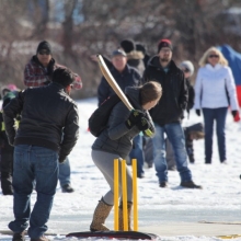 Cavaliers & members of United CC letting boys & girls try cricket (batting) at Waskimo Winter Festival.